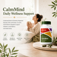 McCord CalmMind supplement bottle with a woman holding a mug in a cozy room.