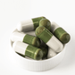 Brain health supplement bottle highlighting green/white capsules