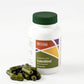 Green capsules sitting next to white bottle with green cap