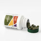 Green capsules sitting next to white bottle with green cap
