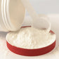 Powder and scoop coming out of canister and spilling on lid