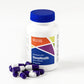 Purple and white capsules sitting next to white bottle